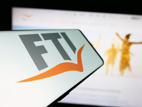 Stuttgart, Germany - 04-15-2024: Smartphone with logo of German travel company FTI Touristik GmbH in front of business website. Focus on center-left of phone display.