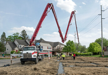 Construction Crew Pumping Concrete into Housing Development Footer © lawcain