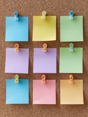 Six blank pastel-colored post-it notes are pinned neatly to a brown cork board
