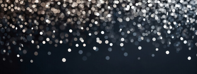 Abstract background with slate gray and silver particles. Christmas silver light shine particles bokeh on charcoal backdrop. Silver foil texture. Holiday concept.