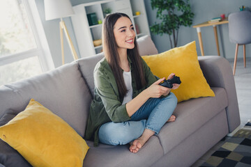Full size photo of pretty young woman playing games wear shirt modern interior apartment indoors