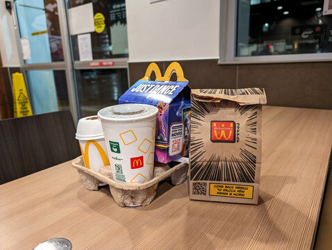 Fast Food Meal From McDonalds Featuring Happy Meal, Fries, and Drinks on Restaurant Table