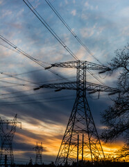 Power grid transmission towers network against blue sky portrait orientation