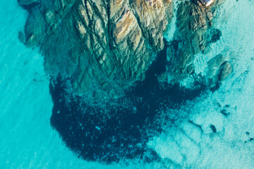 Aerial view of turquoise rocky shore