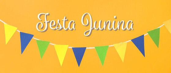 Colorful flags for Festa Junina on orange background