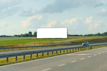Large Billboard Displayed Alongside Busy Highway