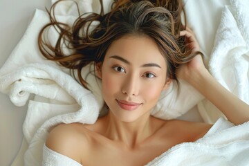 Tranquil and serene beauty of a young female lying down in a peaceful and graceful repose. Surrounded by soft white fabric. Exuding elegance and delicate features