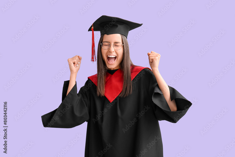 Wall mural cheerful female graduate on lilac background