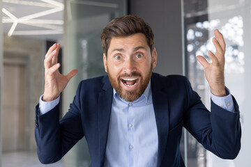 Excited businessman celebrating success with animated expression