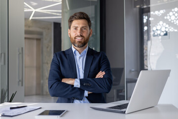 Confident businessman standing in modern office setting