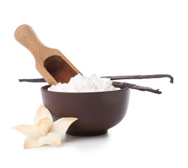 Bowl of vanilla powder with sticks and flower on white background