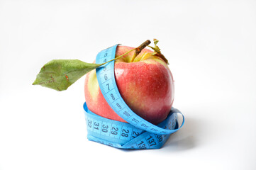 red apple and soft centimeter on a white background. diet and proper nutrition. fight against...