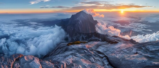 Naklejka premium A stunning sunrise over the majestic Mount Kinabalu, the highest mountain in Borneo.