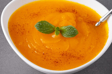Pumpkin soup on grey background