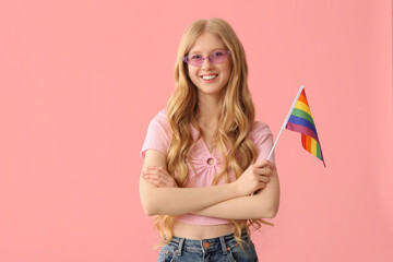 Beautiful young happy woman with LGBT flag on pink background