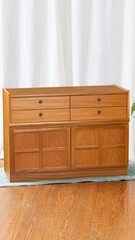 Vintage teak sideboard, Stylish Mid-century Modern small footprint credenza. Product photograph.