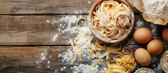 Homemade pasta and pasta ingredients displayed on a wooden background - Powered by Adobe