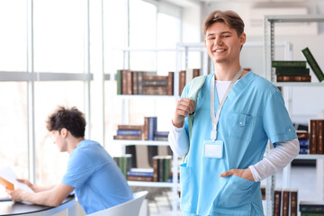 Obraz premium Male medical intern with backpack in library