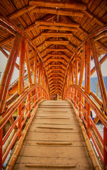 orange guadua bridge on the lake