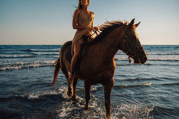 Woman taking a romantic horse ride along a shoreline with her rearing stallion
