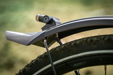 rear wheel of a trekking bike, splash guard and rear light, close-up