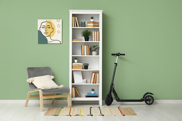 Electric scooter, shelving unit and grey armchair in living room
