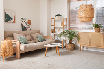 Cozy sofa, chest of drawers and shelving unit in interior of living room