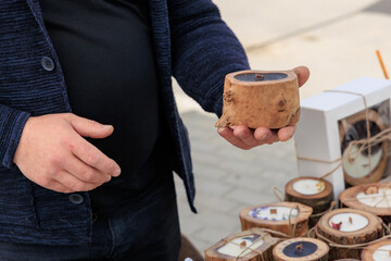 Man holding a wooden object, craft organic scented candles