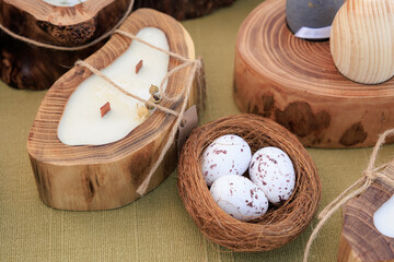 A wooden bowl with three eggs in it sits on a table