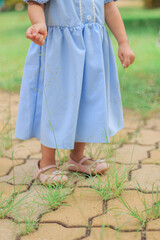 Little Girl holding Grass