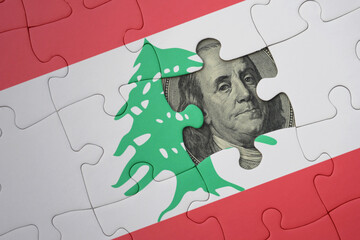 puzzle with the national flag of lebanon and usa dollar banknote. finance concept