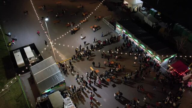 Multitud de gente haciendo fila en un evento nocturno.