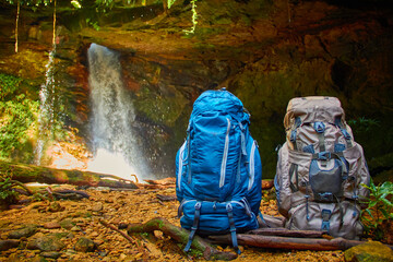 Travel backpacks in the waterfall 