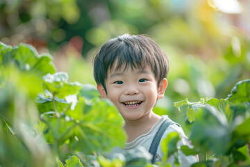 Asian boy kid smiling in the middle of a vegetable garden. 