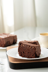 Fresh homemade chocolate sponge cake on wooden board