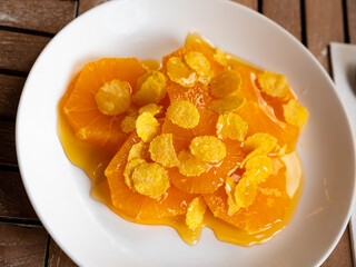 Orange slices in honey served with corn flakes for dessert