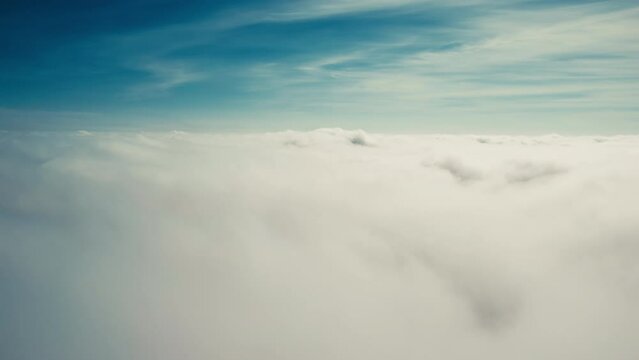 Flying down through moving clouds