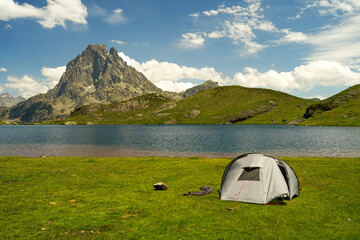 Tent near beautiful mountain lake in Pyrenees (Lacs d' Ayous), camping on popular hiking route,...