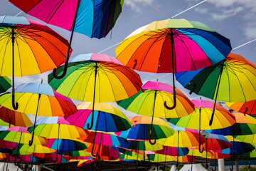 Fototapeta na wymiar Many colorful umbrellas. Umbrella in the air.