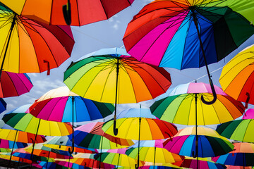 Fototapeta na wymiar Many colorful umbrellas. Umbrella in the air.