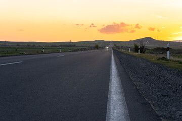 Asphalt road at sunset, travel concept