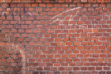 Naklejka premium Dirt wall made of red brick