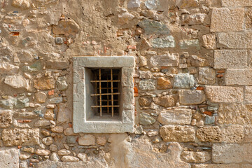 Old wall with a small window