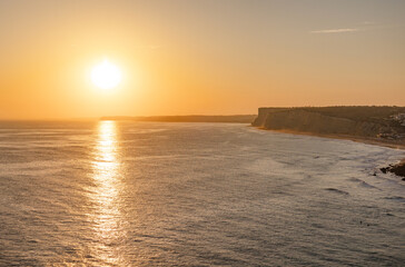 Tranquil sunset scenery at the ocean with the sunlight reflected on the water. Lagos, Portugal on October 10, 2023.