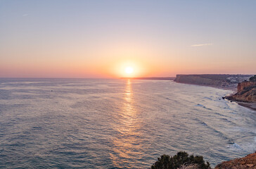 Tranquil sunset scenery at the ocean with the sunlight reflected on the water. Lagos, Portugal on...