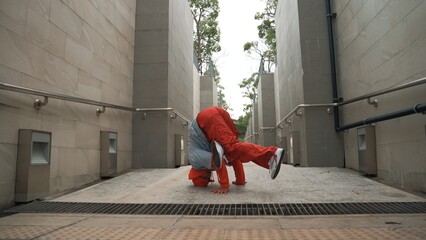Professional hipster doing freeze pose while wear stylish cloth. Skilled street dancer show b-boy...