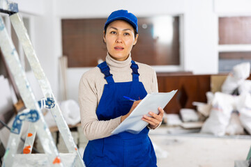 Portrait of an asian builder woman who checks the completed work on