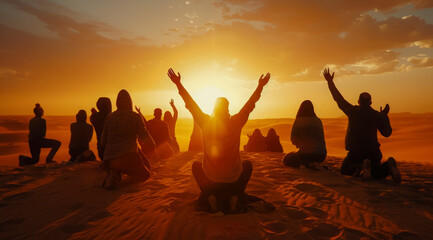 Kneeling people praying to god and Jesus in the desert. Scenic dramatic sunset