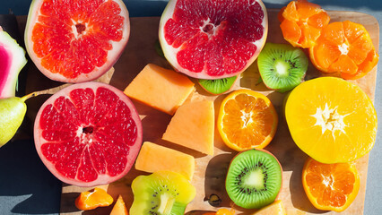 bright and colorful fruits sliced ​​and displayed on a billboard, pictured in dramatic sunlight