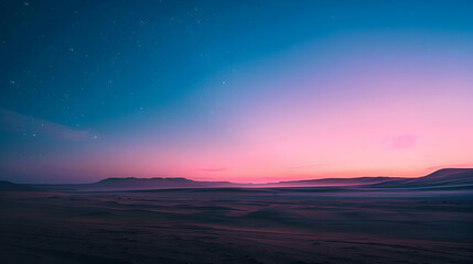 Twilight in the desert showing the transition from day to night with a gradient of blue to purple in the sky and the first stars appearing
